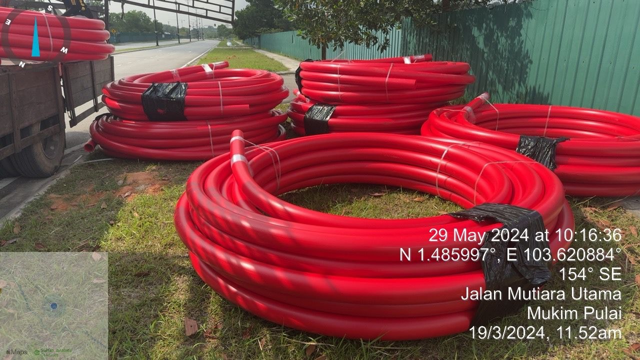 Red HDPE duct coils staged at Jalan Mutiara Utama, Mukim Pulai, Johor (29 May 2024).